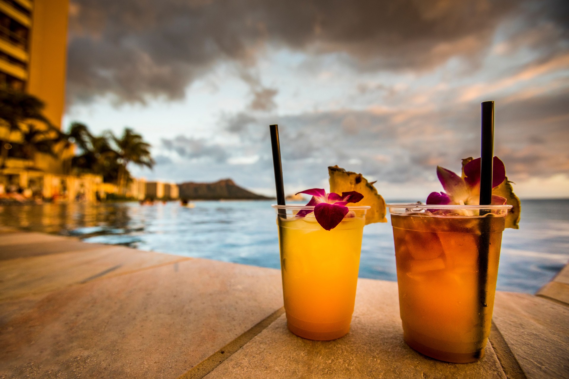 Cocktail drinks on beach at sunset.